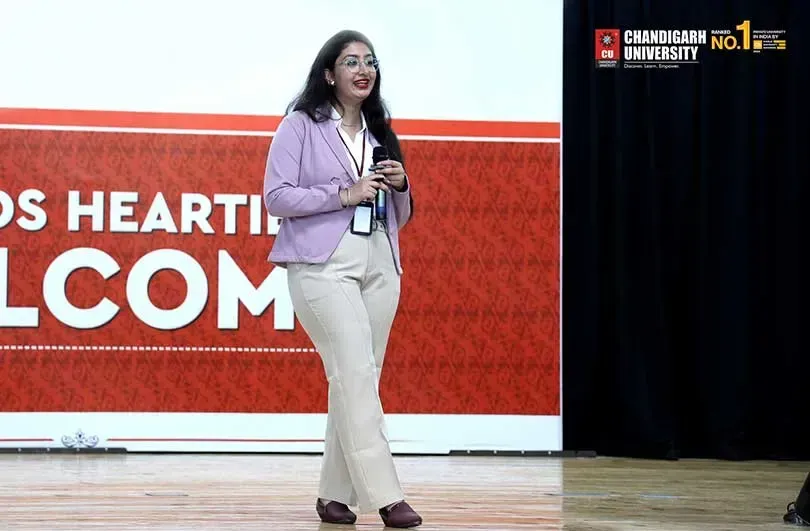 A speaker addressing an audience on a stage