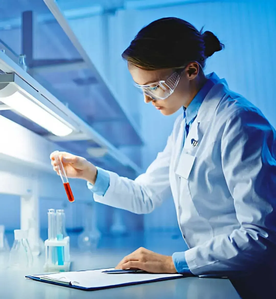 A researcher working with test tubes in a laboratory
